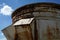 An old rusted silo photographed in a port area in summer