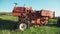 Old rusted tractor aged on farm land. Abandoned agricultural machinery