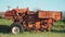 Old rusted tractor aged on farm land. Abandoned agricultural machinery