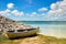 old rustic bot next to a pile of mussels on the sandy beach of the caribbean island in bonaire. Netherlands Antilles.