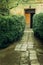 Old rustic building with wooden doors and geen garden, italian p