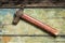 Old rustic hammer on wood background
