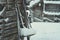 Old rustic houses made of timber and covered in snow. Some tools on the side of the wooden house. Snowy village in Lapland,