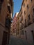 Old rustic mediterranean traditional house facade wall narrow alley lane road street in Toledo Castilla La Mancha Spain