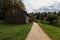 An old rustic stone barn for storing grain and grain near an earthen path