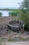 Old rustic timber rowboat filled with straws abandoned next to a lake