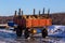 Old rustic trailer with firewood lumber leftovers at winter daylight