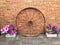 Old rustic wagon wheel and flower display