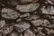 Old rustic wall made of stone. Close up view of abstract stonewall as texture and background.