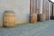 Old rustic wine barrels in front of modern wine cellar. Wine background in Europe. Czech Republic, South Moravia