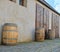 Old rustic wine barrels in front of modern wine cellar. Wine background in Europe. Czech Republic, South Moravia