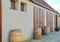 Old rustic wine barrels in front of modern wine cellar. Wine background in Europe. Czech Republic, South Moravia