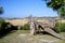 Old Rustic Wooden Carriage Overlooking a Farm Field