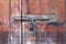 Old and rustic wooden door with a rusty latch