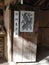 An old rustic wooden door with a sketch of parrot and four-legged animal. Words in Chinese written â€œSweep the Gold outâ€