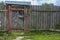 Old rustic wooden gate in natural village fence. Countryside rural scene, agrotourism