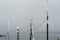 Old rustic wooden poles with power line wires covered with snow after a snowfall