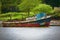 Old rusting boat sits tied at dock