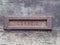 an old rusting iron letterbox in a black wooden door with chipped peeling paint with the word correio