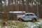 Old rusty abandoned car in the forest. Lost Old russian auto