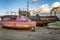 Old rusty abandoned ship on the shore. Gloomy northern nature