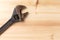 Old, rusty adjustable wrench on wooden background. Top view. Flat lay