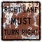 Old rusty American road sign - Right lane MUST turn right sign
