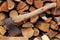 An old rusty axe on the background of a stack of firewood