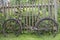 Old rusty bicycle leaning against a wooden fence
