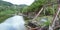 An old rusty bridge partially broken in half after a hurricaine.