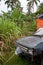 An old, rusty and broken car left in a backyard in Eua in Tonga