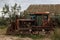 Old rusty broken rural tractor stands in the backyard