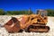 Old rusty bulldozer in abandoned stone pit