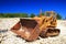 Old rusty bulldozer in abandoned stone pit