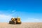 Old rusty bulldozer tractor on a pebble beach