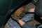 Old rusty car rear brakes. Close-up of worker repairing faulty part at car, unrecognizable person