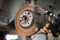 Old and rusty car`s suspension parts. Rusted disc brake and caliper on the car. Automotive industry and garage concepts.