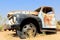 Old and rusty car wreck at the last gaz station before the Namib desert