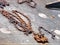 Old rusty chain attached to metal dock along harbor