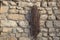 Old rusty chain hanging on the wall of a village house