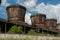 Old rusty cooling towers against a blue sky