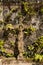 Old rusty crucifix affixed to old stone wall