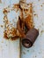 An old rusty cylinder padlock on a rusty metal gate