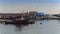 Old rusty and dirty ships and boats moored at small fishing port.