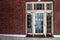 Old rusty doors in red brick wall