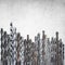 Old rusty drill bits of different sizes  on grunge background