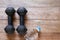 Old rusty dumbbells with drinking water bottle on vintage wooden floor