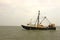 Old, rusty fishing trawler in early morning mist