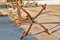 Old rusty four-legged anchor in the seaport Anapa