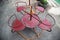 Old rusty four-seater round seesaw